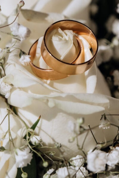 Golden wedding rings on the white rose  from the wedding bouquet